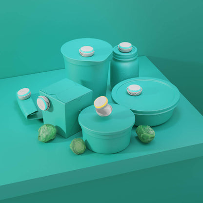 Main image for Ovie LightTag set of 6 on stylized teal green background. All 6 LightTags are lit up and propped on food containers that are colored real to match  background. Image is propped with brussels sprouts.