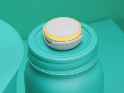 Stylized mostly-teal image focused on jar with Ovie LightTag on top lit up yellow
