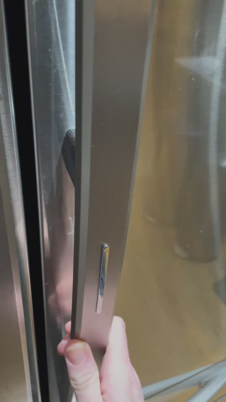 Video of someone opening a fridge and zoom into two food containers on the bottom shelf. One of the food containers has a LightTag on top that is blinking teal.