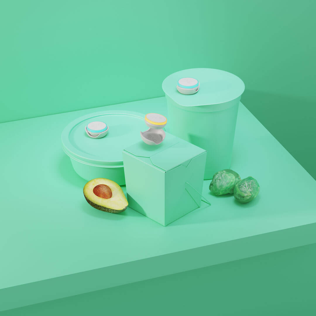 Main image for Ovie LightTag set of 3 on stylized all-pale green background. All 3 LightTags are lit up and propped on food containers that are colored pale green to match pale green background. Image is propped with brussels sprouts and a half of an avocado