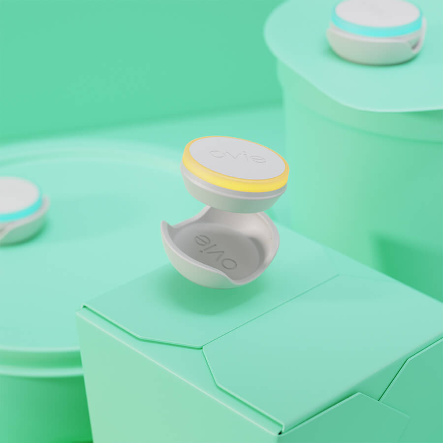 Close up image of Ovie LightTag and connector landing on top of takeout container. Ovie LightTag is lit up yellow and everything but the LightTags is colored pale green