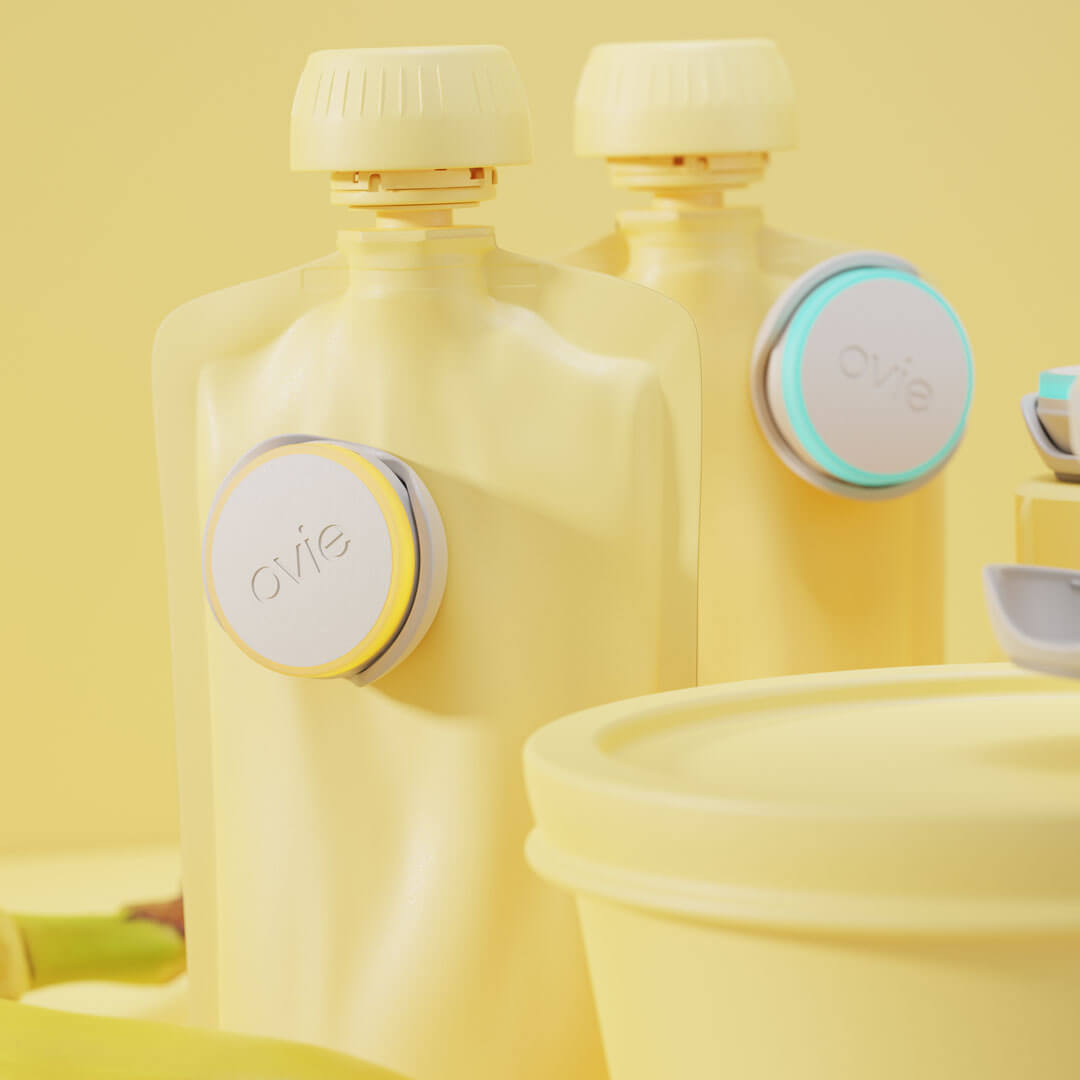 Closeup stylized rendering of 2 Ovie LightTags attached to 2 baby food pouches.Background and foods in rendering are all colored light yellow