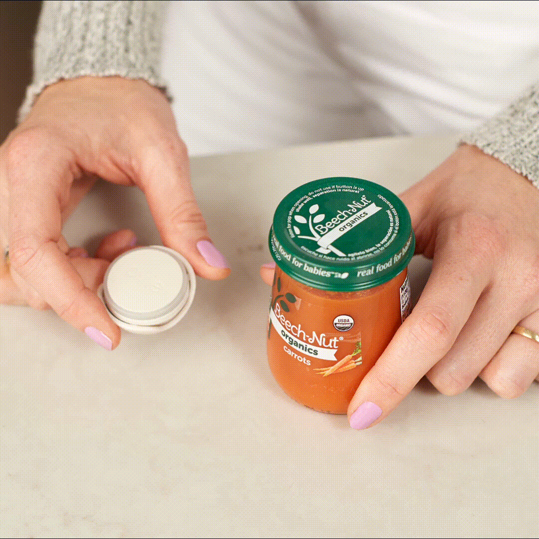 Gif of woman putting Ovie LightTag on baby food jar and pushing the button on top of it, which turns the LightTag light Teal